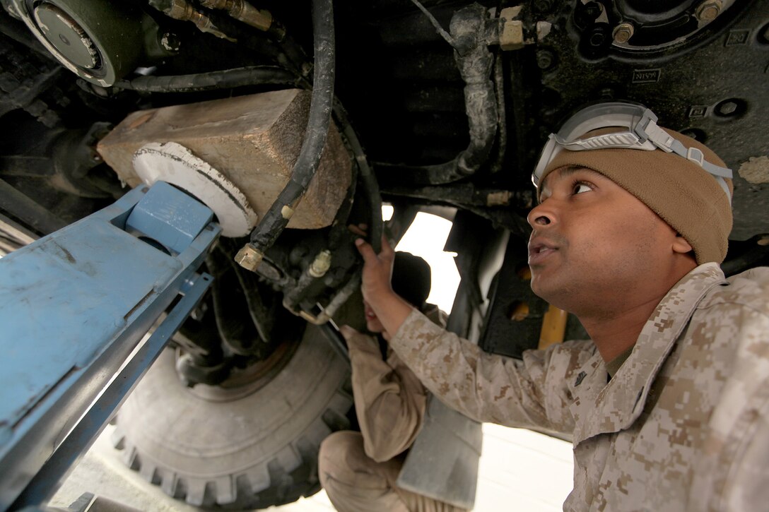 Sgt. Christopher Williams, 22nd Marine Expeditionary Unit motor transport operations chief and New York-native, checks the placement of a steering gear underneath a seven-ton truck at the unit's motor pool aboard Marine Corps Base Camp Lejeune, N.C., April 4, 2013.  The MEU's motor transport section provides weekly preventative and annual maintenance to all the unit's vehicles in order to maintain a high state of unit readiness. (Marine Corps Photo by Lance Cpl. Caleb McDonald/Released)