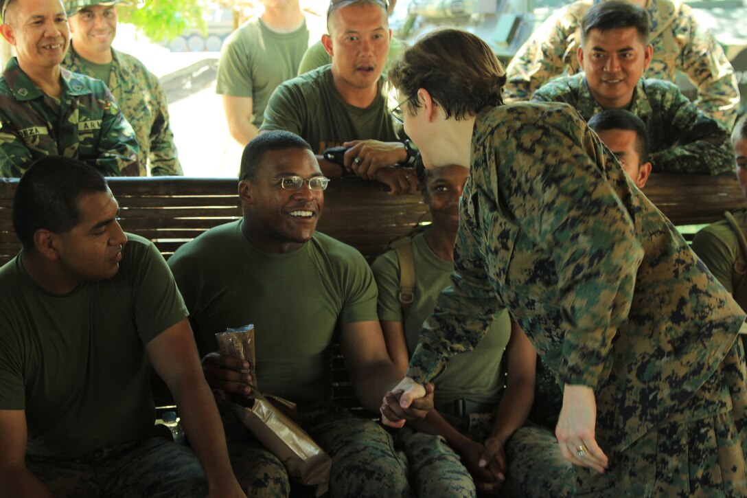 Chaplain of the U.S. Marine Corps, U.S. Navy Rear Adm. Margaret Grun Kibben, greets members of the Armed Forces of the Philippines and U.S military April 10 during a bilateral motor transportation, maintenance and welding expertise exchange as a part of the field training exercise of Balikatan 2013 at Camp O'Donnell, Philippines. BK13 is a bilateral joint exercise between AFP and U.S. forces designed to enhance interoperability, multinational cooperation and military-to-military relationships.