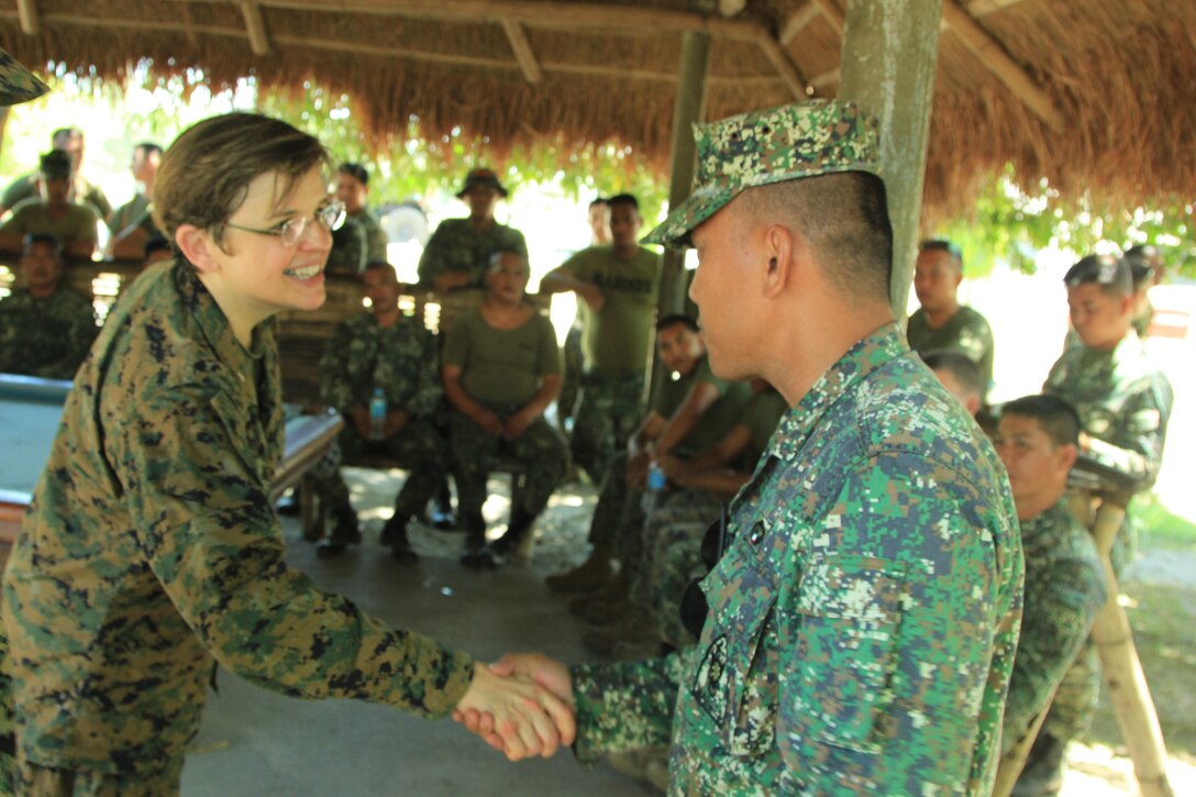 Chaplain of the U.S. Marine Corps, U.S. Navy Rear Adm. Margaret Grun Kibben, shakes hands with Philippine Marine Capt. Recto C. Pumares, Motor Transportation and Support Battalion, Combat Service Support Brigade, April 10 during a bilateral motor transportation, maintenance and welding expertise exchange as a part of the field training exercise of Balikatan 2013 at Camp O'Donnell, Philippines. BK13 is a bilateral joint exercise between AFP and U.S. forces designed to enhance interoperability, multinational cooperation and military-to-military relationships.