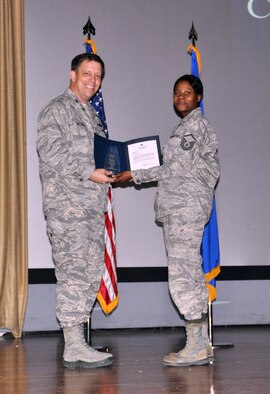 NELLIS AIR FORCE BASE, Nev. -- (Right) Master. Sgt. Vickie Tippitt, 926th Force Support Squadron knowledge operations manager, is presented with Air Force Reserve Command's Outstanding Cyberspace Operations Senior Noncommissioned Officer of the Year award by Col. John Breeden, 926th Group commander, here April 6. Tippitt led the management of communications requirements for the 926th GP, to include computer inventory, networking capabilities, wireless devices and system upgrades. Additionally, she was sought out by 10th Air Force to prepare workcenters for organizational restructure. (U.S. Air Force photo/Maj. Jessica Martin)