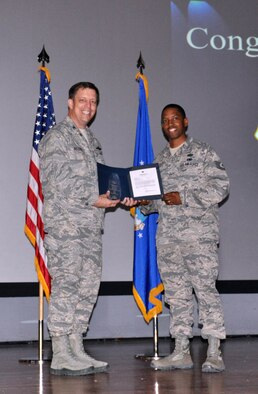 NELLIS AIR FORCE BASE, Nev. -- (Right) Tech. Sgt. Natrell Curry, 926th Force Support Squadron cyberspace systems operator, is presented with Air Force Reserve Command's Outstanding Knowledge Operations Management Noncommissioned Officer of the Year award by Col. John Breeden, 926th Group commander, here April 6. Curry developed numbered Air Force-wide records management procedures, and was selected by 10th Air Force to conduct geographically-separated units remote access records management staff assistance visits to ensure programs complied with AFRC standards. (U.S. Air Force photo/Maj. Jessica Martin)