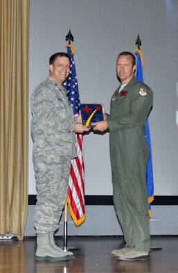 NELLIS AIR FORCE BASE, Nev. -- (Right) Maj. Matthew Allen, 706th Fighter Squadron, receives the award for the 926th Group Field Grade Officer of the Year from Col. John Breeden, 926th Group commander, here April 6. Allen led an F-22 division, coordinating tests and exercises which ensured the aircraft's interoperability with other aircraft. (U.S. Air Force photo/Maj. Jessica Martin)