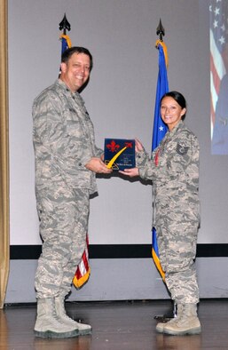 NELLIS AIR FORCE BASE, Nev. -- (Right) Tech. Sgt. Deana Williams, 926th Aerospace Medicine Squadron, receives the award for the 926th Group Noncommissioned Officer of the Year from Col. John Breeden, 926th Group commander, here April 6. Williams revamped the unit health monitor program, improving overall individual medical readiness metrics. (U.S. Air Force photo/Maj. Jessica Martin)