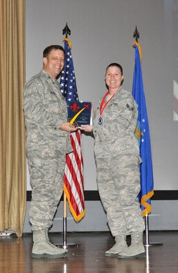 NELLIS AIR FORCE BASE, Nev. -- (Right) Senior Airman Crystal, 91st Attack Squadron, receives the award for the 926th Group Airman of the Year from Col. John Breeden, 926th Group commander, here April 6. (U.S. Air Force photo/Maj. Jessica Martin)