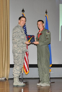 NELLIS AIR FORCE BASE, Nev. -- (Right) Maj. Scott Petz, 706th Fighter Squadron, receives the award for the 926th Group Flight Commander of the Year from Col. John Breeden, 926th Group commander, here April 6. Integrated with the Regular Air Force here, Petz managed the squadron's manning program of more than 4,000 flying hours. (U.S. Air Force photo/Maj. Jessica Martin)