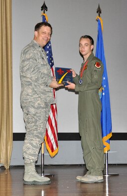 NELLIS AIR FORCE BASE, Nev. -- (Right) Staff Sgt. Tyson, 78th Attack Squadron, receives the award for the 926th Group Trainer of the Year from Col. John Breeden, 926th Group commander, here April 6. (U.S. Air Force photo/Maj. Jessica Martin)