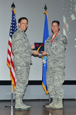 NELLIS AIR FORCE BASE, Nev. -- (Right) Master Sgt. Cal, 78th Attack Squadron, receives the award for 926th Group First Sergeant of the Year from Col. John Breeden, 926th Group commander, here April 6. (U.S. Air Force photo/Maj. Jessica Martin)