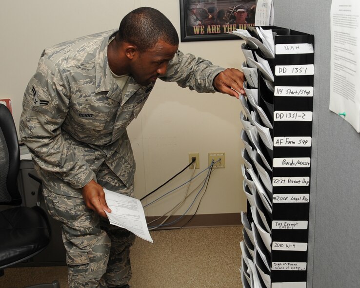 Airman 1st Class Irthgar Berry, 2nd Comptroller Squadron, looks for a form at Finance on Barksdale Air Force Base, La., April 15, 2013. The finance section can assist with issues regarding the Defense Travel System, Government Travel Cards, LeaveWeb and My-Pay. The Finance mission is to provide high-quality, objective guidance to the decision maker as well as customer-focused financial services to the war fighter. (U.S. Air Force photo/Senior Airman Sean Martin)