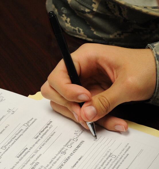 An Airman fills out a form during an in-processing brief on Barksdale Air Force Base, La., April 15, 2013. The brief is used to help Airmen with their travel vouchers and is given every Monday, Wednesday and Friday at 1 p.m. (U.S. Air Force photo/Senior Airman Sean Martin)