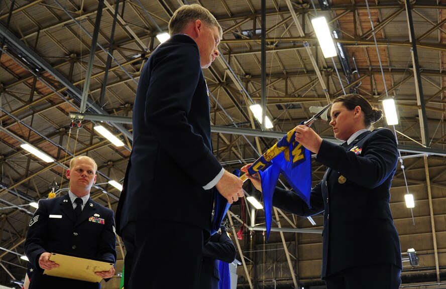 Maj.Wendy Enderly, 92nd Maintenance Operations Squadron commander, and Lt. Col. Alan Hart, 92nd Maintenance Group commander, in-activate the 92nd Maintenance Operation Squadron at Fairchild Air Force Base, Wash., April 12, 2013. The 92nd MOS has distinguished itself with several notable achievements to include the 2010 Headquarters Air Force General Thomas P. Gerrity Award and the 2011 Mobility Air Force Maintenance Training Flight of the year. (U.S. Air Force photo by Airman 1st Class Janelle Patño)