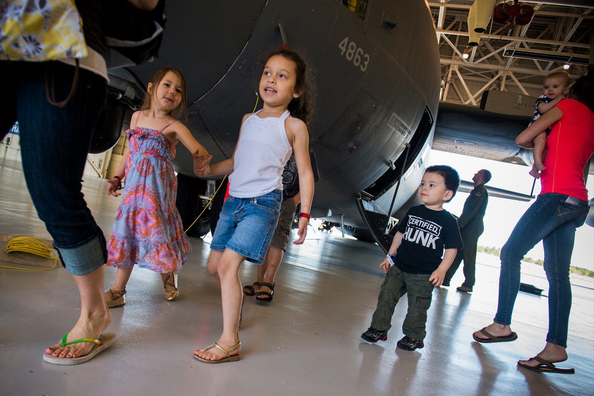 Families exit the fuels barn hangar after touring an HC-130P Combat King during a Kids Deployment Line April 13, 2013, at Moody Air Force Base, Ga. Children got an up-close view of the aircraft with a chance to sit in the cockpit. (U.S. Air Force photo by Staff Sgt. Jamal D. Sutter/Released) 