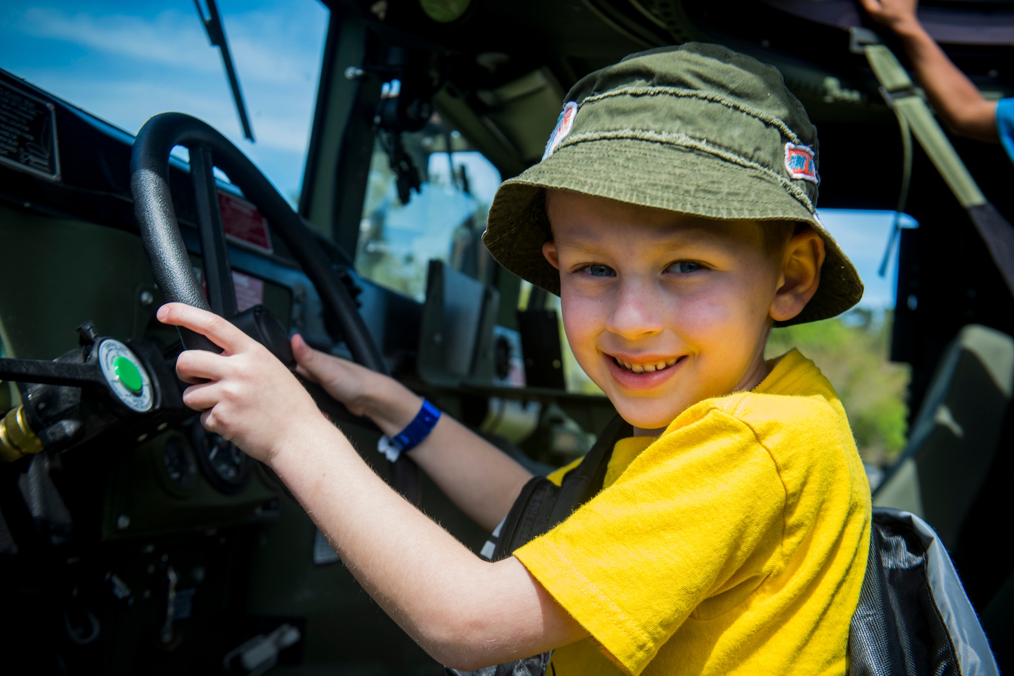 Trey Hartley, son of U.S. Air Force Tech. Sgt. Keith Anson, 23d Mission Operations Squadron, sits in a Humvee driver’s seat during a Kids Deployment Line April 13, 2013, at Moody Air Force Base, Ga. A military working dog demonstration, obstacle course and bounce houses were available for children to take part of. (U.S. Air Force photo by Staff Sgt. Jamal D. Sutter/Released) 