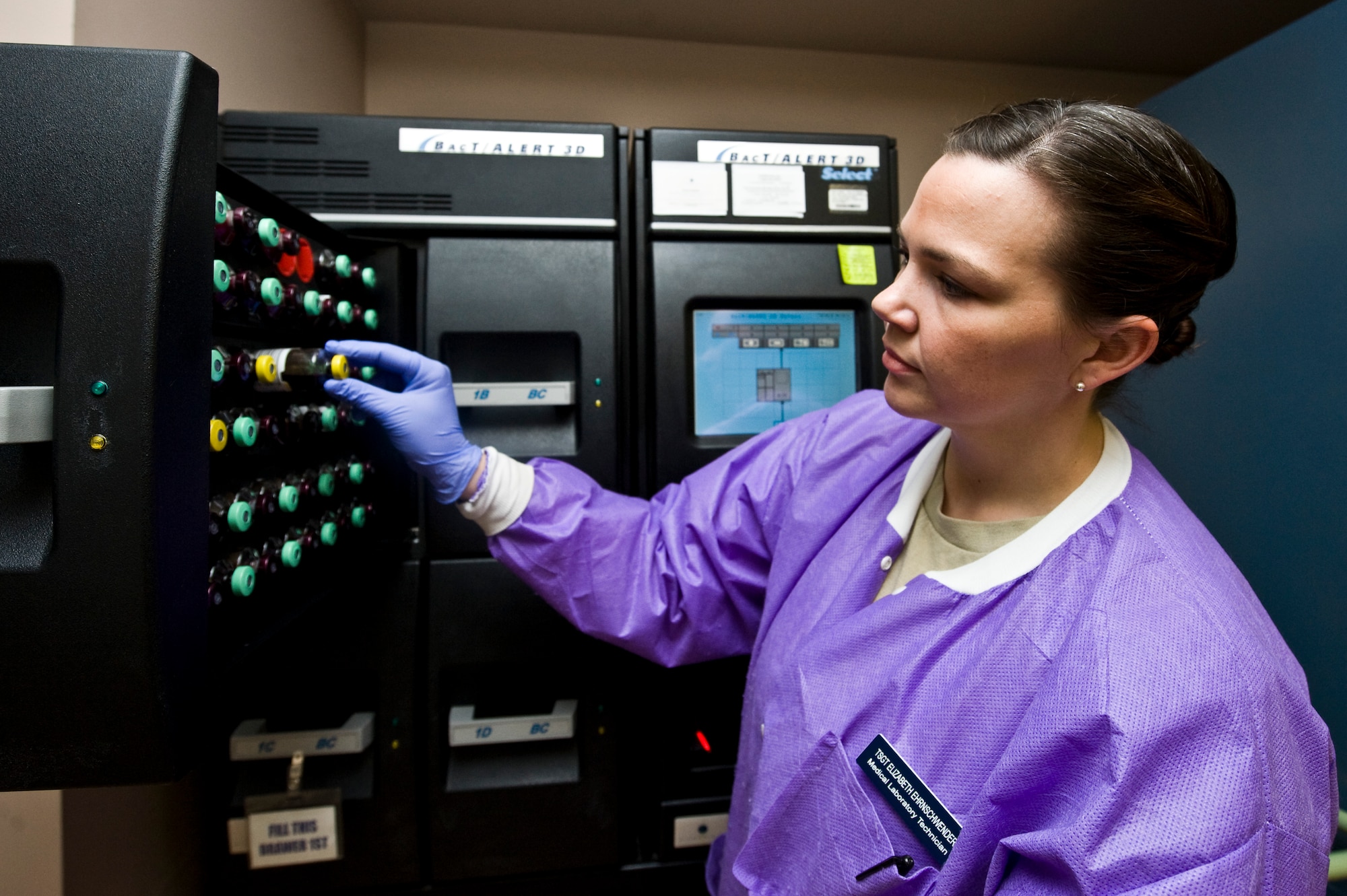 Tech. Sgt. Elizabeth Ehrnschwender, 99th Medical Support Squadron NCO in charge of microbiology, unloads blood cultures from the BacT/ALERT 3D machine April 10, 2013, at Nellis Air Force Base, Nev.  The BacT/ALERT 3D is used for sepsis risk stratification and monitoring for the presence or absence of microorganisms in blood, sterile body fluids, and mycobacteria. Early detection of sepsis is important because it is a potentially deadly medical condition characterized by a whole-body inflammatory state caused by severe infection. (U.S. Air Force photo by Airman 1st Class Jason Couillard)