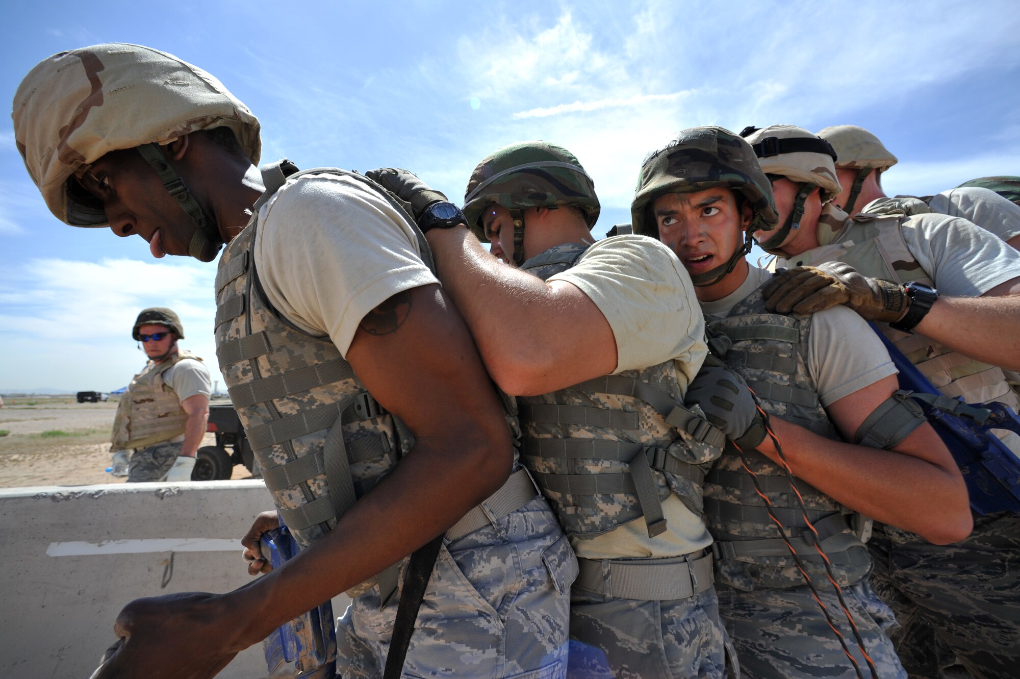 2nd Lt. Joseph Matejcik, 56th Civil Engineer Squadron, and his team members perform the walking board obstacle April 4 during the Prime BEEF challenge held at the ATSO area. (U.S. Air Force photo/Senior Airman Sandra Welch)