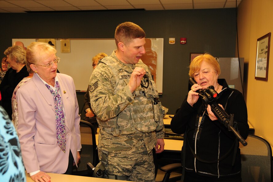 Staff Sergeant John Goodenbury, 914th Airlift Wing Security Forces member demonstrates some of the various weapons that Air Force security forces use in their line of work to members of the Western New York FBI Alumni Association and their guests at the Niagara Falls Air Reserve Station on April 15, 2013. The group toured the air station and were briefed on many facets of what the units at Niagara do. (U.S. Air Force photo by Peter Borys.)
