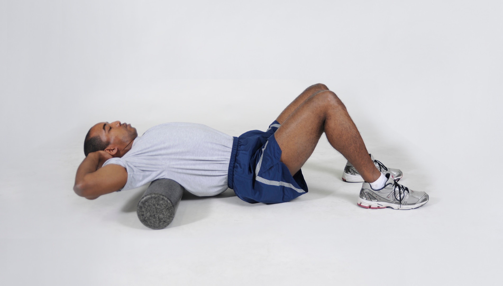 Thoracic Foam Roll
Lie face up with a foam roller under the upper back, at the top of the shoulder blades. Cross the arms over the chest or clasp behind the head with elbows back. The knees should be bent, with the feet flat on the floor. Raise the hips so they’re slightly elevated off the floor. Roll back and forth over the shoulder blades, middle back and upper back. 
