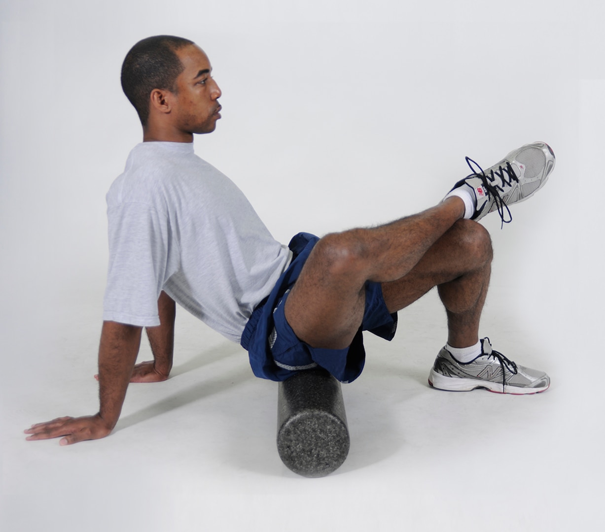 Glutes Foam Roll
Sit on a foam roller with it positioned on the right glute. Cross the right leg over the front of the left thigh and put hands on the floor for support. Roll the body forward and backward in small movements from the lower glute to the upper glute. Repeat with the roller under the left glute.
