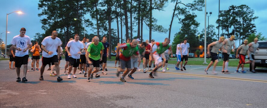 Members of Team Moody take off at the start of a Warrior 5K run April 12, 2013, at Moody Air Force Base, Ga. The 5K was a team race of groups of four, and all members had to cross the finish line before the groups’ time was announced. (U.S. Air Force photo by Airman Alexis Grotz/Released)