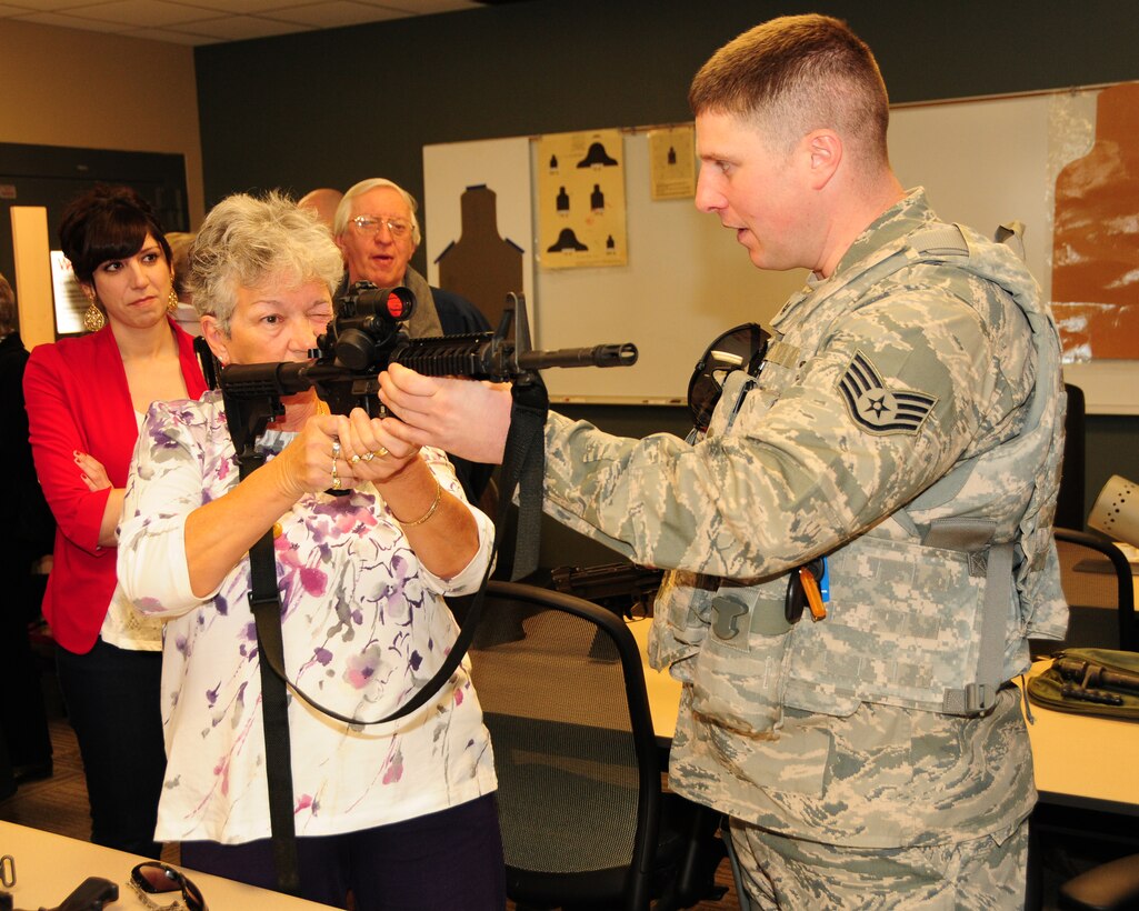 Staff Sergeant John Goodenbury, 914th Airlift Wing Security Forces member demonstrates some of the various weapons used by Air Force Security Forces in their line of work to members and guests of the Western New York FBI Alumni Association at the Niagara Falls Air Reserve Station on April 15, 2013. The group toured the air station and were briefed on many facets of what the units at Niagara do. (U.S. Air Force photo by Peter Borys.)