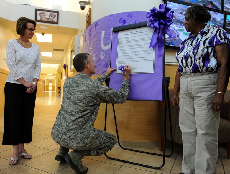 U.S. Air Force Col. Billy Thompson, 23d Wing commander, signs a proclamation for volunteer appreciation at the Child Development Center April 12, 2013, at Moody Air Force Base, Ga. The base will acknowledge volunteers at a recognition ceremony April 25. (U.S. Air Force photo by Airman Alexis Grotz/Released)