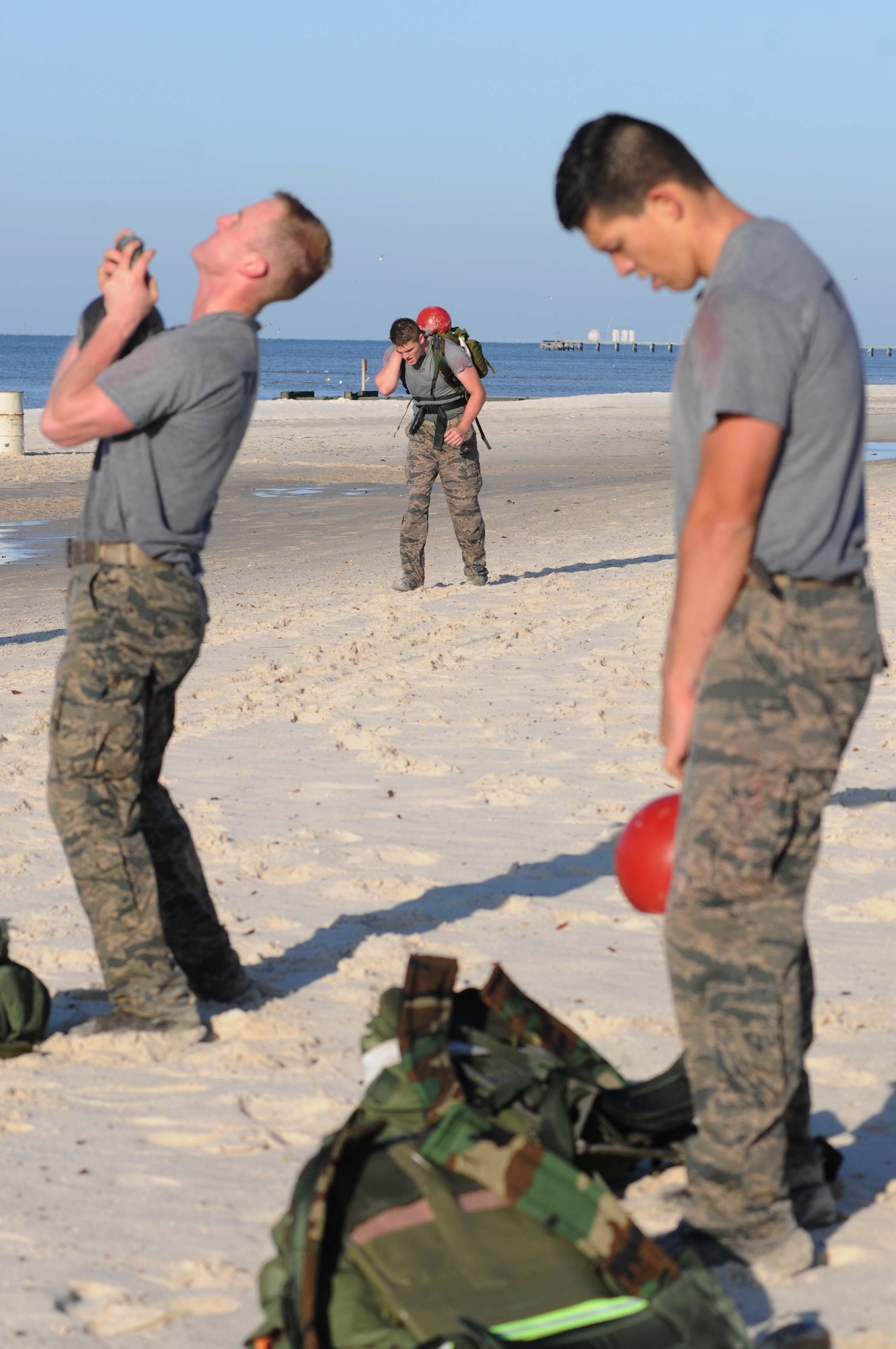 Combat control trainees from the 334th Training Squadron use kettlebells for various workouts during a physical training session April 12, 2013, on Biloxi beach.  Combat controllers are ground troops who are embedded with special forces teams and provide close-air support for special forces units. While at Keesler, trainees learn how to run, swim, carry a rucksack and conduct air traffic control. These Airmen are prepared physically and mentally for the demands of the combat controller pipeline while earning air traffic control certification in just 15 weeks.  (U.S. Air Force photo by Kemberly Groue)