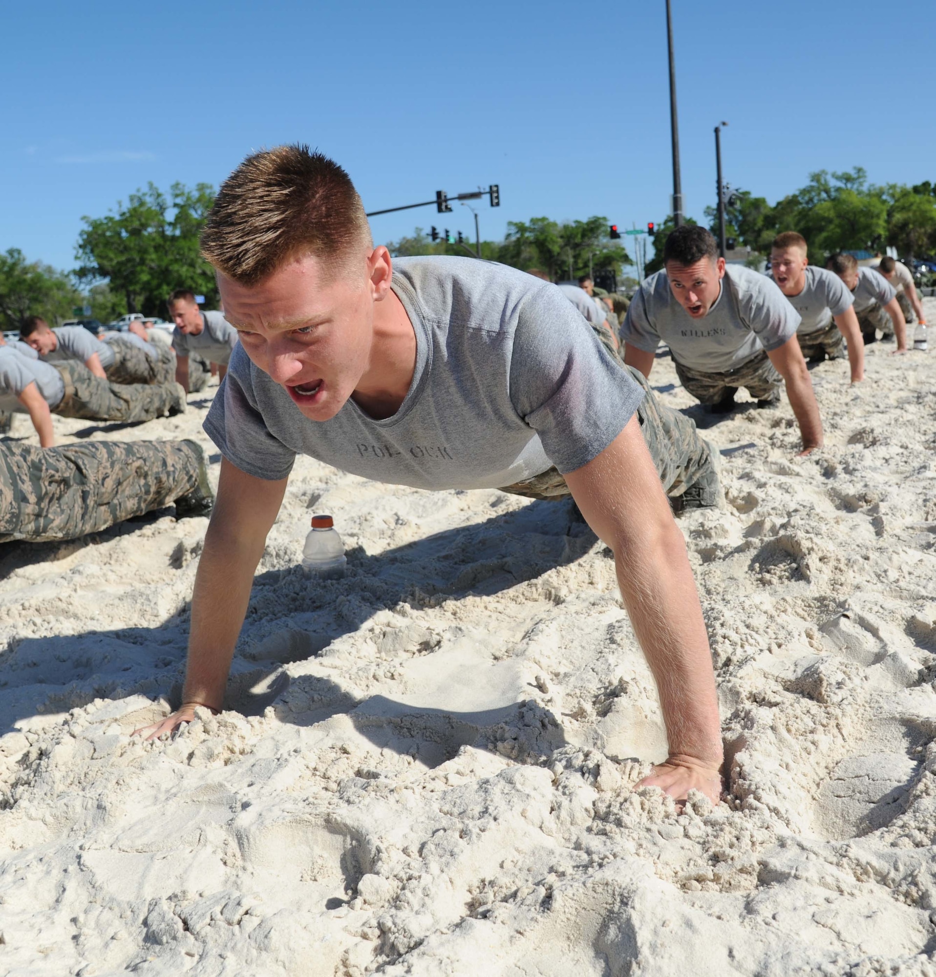 Airman 1st Class Taylor Pollock, 334th Training Squadron, does push-ups during the combat controllers’ physical training session April 12, 2013, on Biloxi beach.  Combat controllers are ground troops who are embedded with special forces teams and provide close-air support for special forces units. While at Keesler, trainees learn how to run, swim, carry a rucksack and conduct air traffic control. These Airmen are prepared physically and mentally for the demands of the combat controller pipeline while earning air traffic control certification in just 15 weeks.  (U.S. Air Force photo by Kemberly Groue)