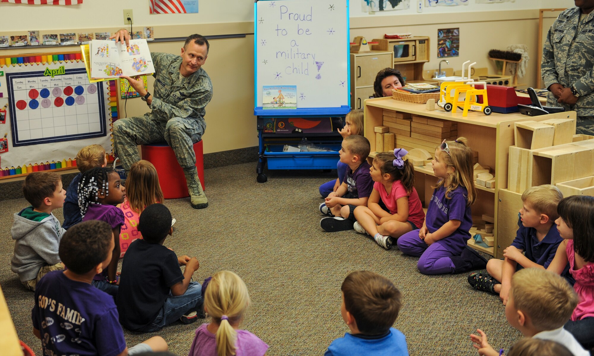 U.S. Air Force Col. Billy Thompson, 23d Wing commander, reads to a class at the Child Development Center April 12, 2013, at Moody Air Force Base, Ga. Thompson read to the children before signing a proclamation for Month of Military Child and Child Abuse Prevention Month. (U.S. Air Force photo by Airman Alexis Grotz/Released)