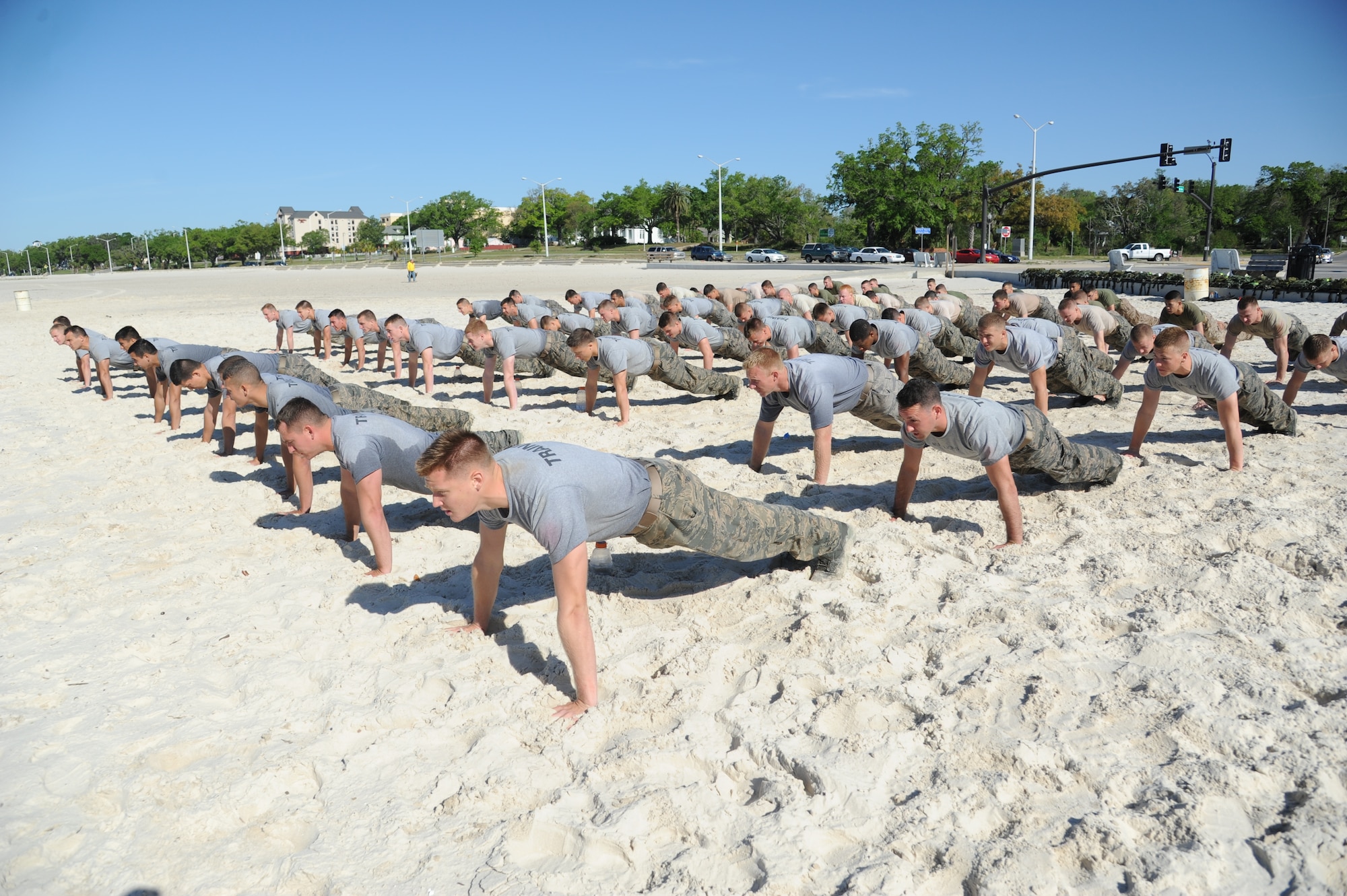 Combat control trainees from the 334th Training Squadron do push-ups during a physical training session April 12, 2013, on Biloxi beach.  Combat controllers are ground troops who are embedded with special forces teams and provide close-air support for special forces units. While at Keesler, trainees learn how to run, swim, carry a rucksack and conduct air traffic control. These Airmen are prepared physically and mentally for the demands of the combat controller pipeline while earning air traffic control certification in just 15 weeks.  (U.S. Air Force photo by Kemberly Groue)