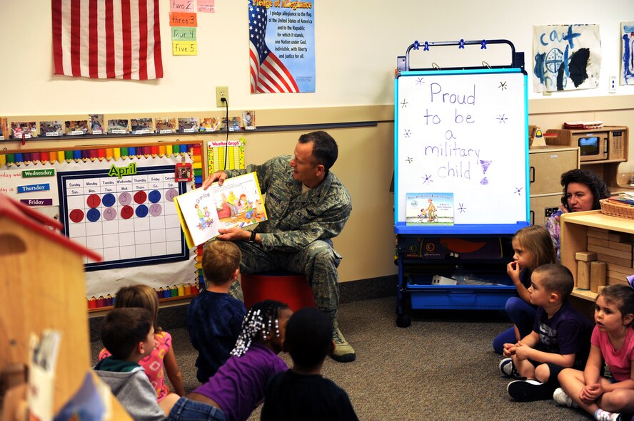 U.S. Air Force Col. Billy Thompson, 23d Wing commander, reads to children at the Child Development Center (CDC) April 12, 2013, at Moody Air Force Base, Ga. Thompson visited the CDC to sign a proclamation for Month of Military Child and Child Abuse Prevention Month. (U.S. Air Force photo by Airman Alexis Grotz/Released)