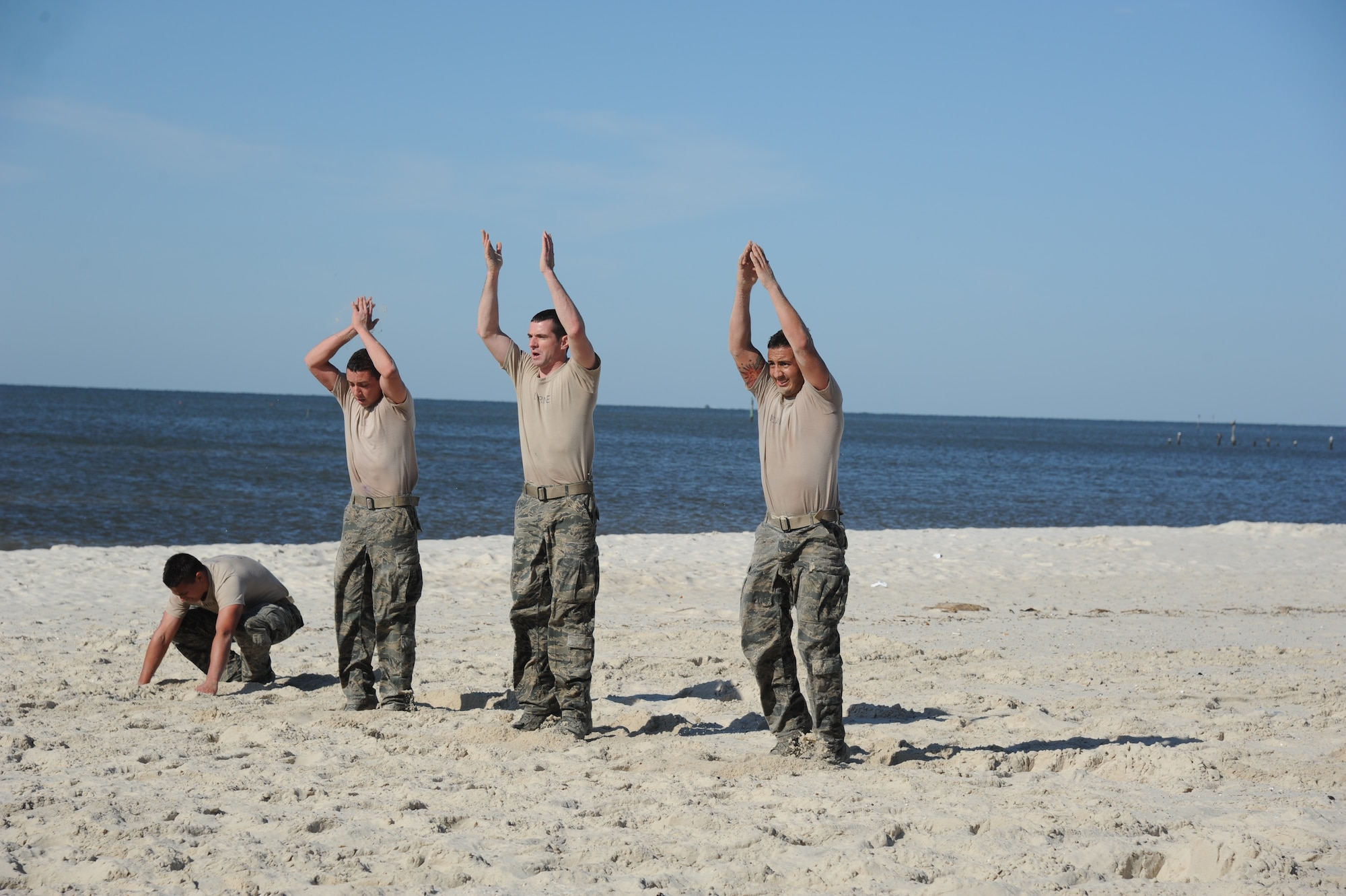 Combat control trainees from the 334th Training Squadron conduct a physical training session April 12, 2013, on Biloxi beach.  Combat controllers are ground troops who are embedded with special forces teams and provide close-air support for special forces units. While at Keesler, trainees learn how to run, swim, carry a rucksack and conduct air traffic control. These Airmen are prepared physically and mentally for the demands of the combat controller pipeline while earning air traffic control certification in just 15 weeks.  (U.S. Air Force photo by Kemberly Groue)