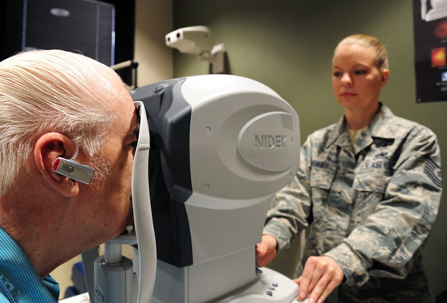 Tech. Sgt. Paula Barkhauer, 92nd Medical Group NCO in charge, uses an autorefractor to determine Dale Taylor's, an Air Force retiree, prescription at Fairchild Air Force Base, Wash., April 11, 2013.  The optometry clinic is not only for active-duty military members, but dependents and retirees as well. (U.S. Air Force photo by Airman 1st Class Janelle Patiño)