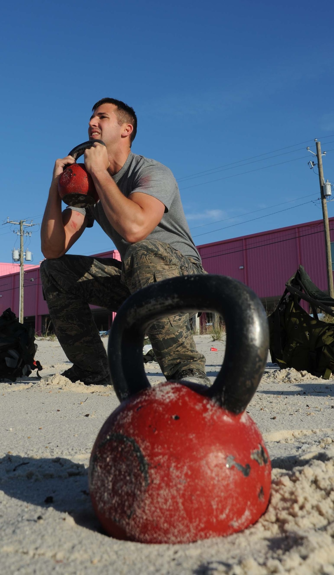 Airman 1st Class Craig Maffei, 334th Training Squadron, does a kettlebell goblet squat during the combat controllers’ physical training session April 12, 2013, on Biloxi beach.  Combat controllers are ground troops who are embedded with special forces teams and provide close-air support for special forces units. While at Keesler, trainees learn how to run, swim, carry a rucksack and conduct air traffic control. These Airmen are prepared physically and mentally for the demands of the combat controller pipeline while earning air traffic control certification in just 15 weeks.  (U.S. Air Force photo by Kemberly Groue)