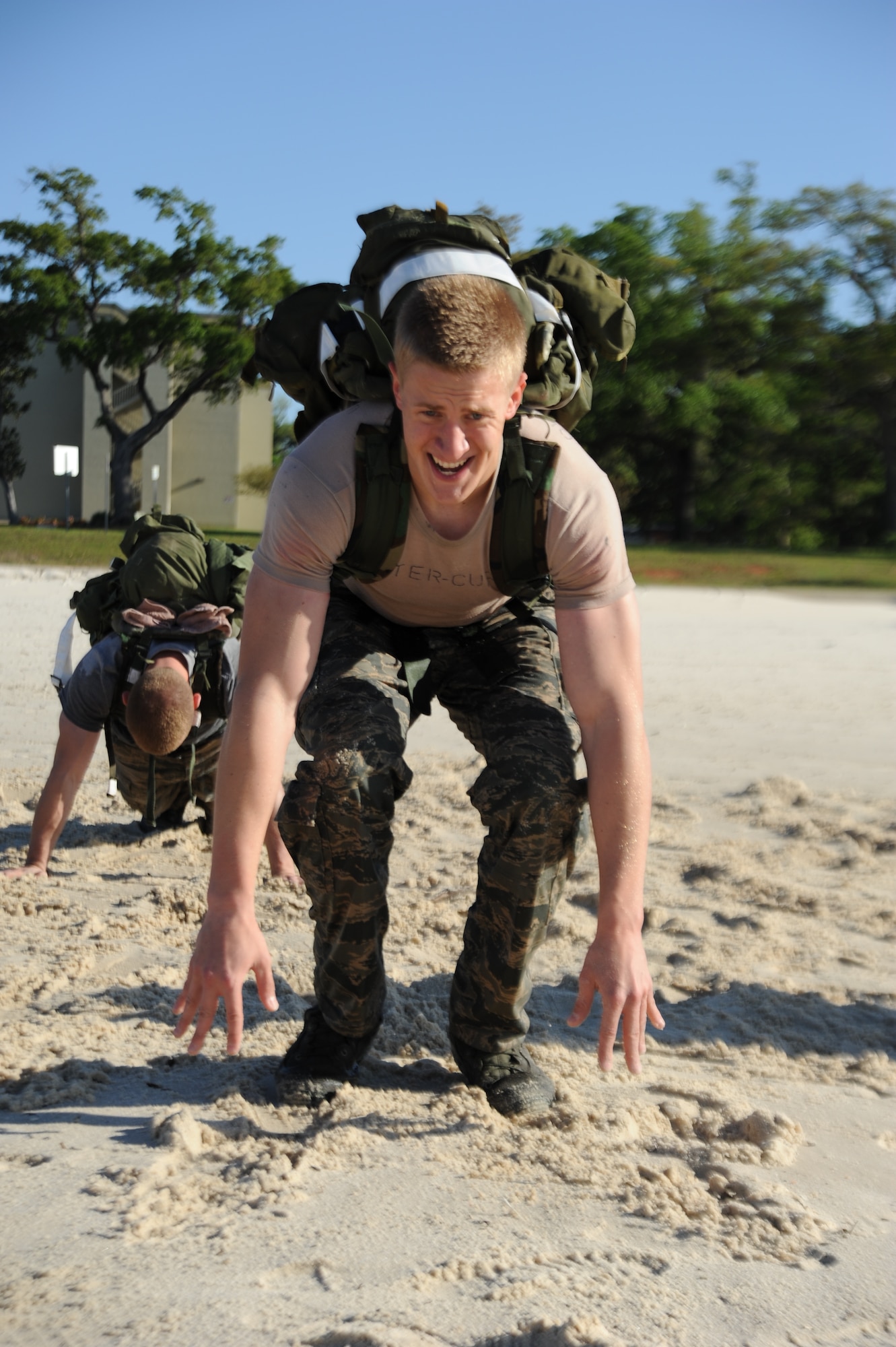 Airman Bailey Quitter-Cuff, 334th Training Squadron, does an exercise during the combat controllers’ physical training session April 12, 2013, on Biloxi beach.  Combat controllers are ground troops who are embedded with special forces teams and provide close-air support for special forces units. While at Keesler, trainees learn how to run, swim, carry a rucksack and conduct air traffic control. These Airmen are prepared physically and mentally for the demands of the combat controller pipeline while earning air traffic control certification in just 15 weeks.  (U.S. Air Force photo by 2nd Lt. Michael Alvarez)