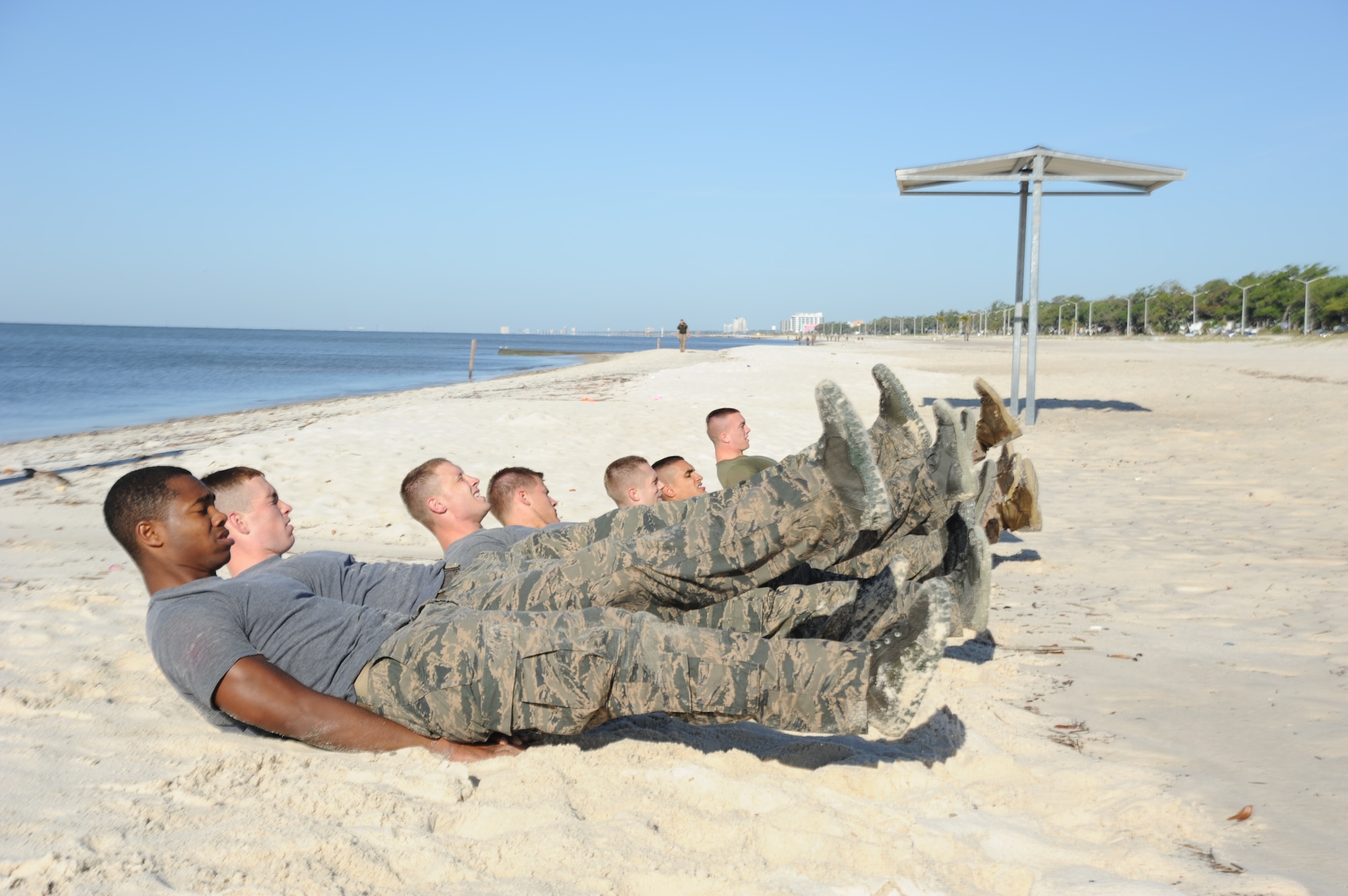 Combat control trainees from the 334th Training Squadron do 100 four-count flutter kicks during a physical training session April 12, 2013, on Biloxi beach.  Combat controllers are ground troops who are embedded with special forces teams and provide close-air support for special forces units. While at Keesler, trainees learn how to run, swim, carry a rucksack and conduct air traffic control. These Airmen are prepared physically and mentally for the demands of the combat controller pipeline while earning air traffic control certification in just 15 weeks.  (U.S. Air Force photo by 2nd Lt. Michael Alvarez)