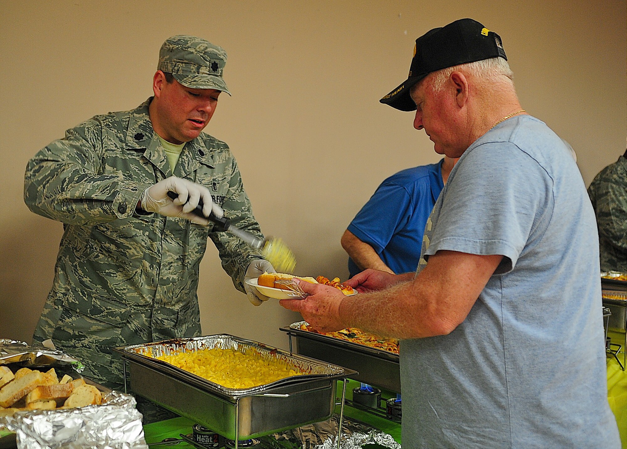 Lt. Col. Darrell Smith, 436th Dental Squadron commander, serves food to William Jones at the Deployed Spouses’ Dinner April 11, 2013, at the Youth Center on Dover Air Force Base, Del. The dinner is a free event for families that are separated due to deployment, extended temporary duties, remote tours and projected deployments. (U.S. Air Force photo/ Airman 1st Class Ashlin Federick)