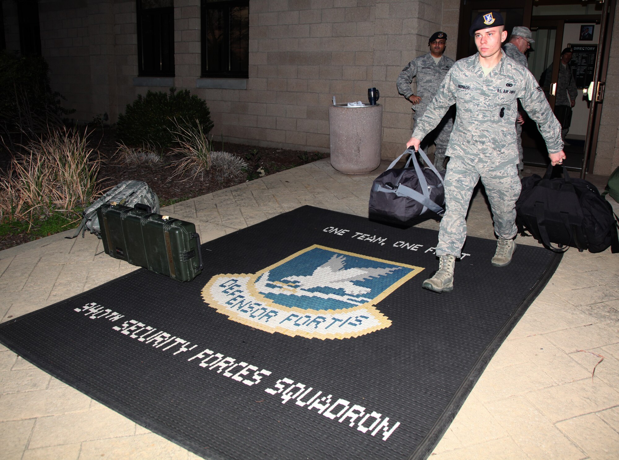 Senior Airman Adam Biernacki, 940th SFS, carries his personal gear and issued items to a bus prior to leaving for Patriot Defender. 13 members of the squadron departed Beale April 13 for the fifteen day exercise in Ft Wolton,Texas. (U.S. Air Force Photo/TSgt Kenny McCann)