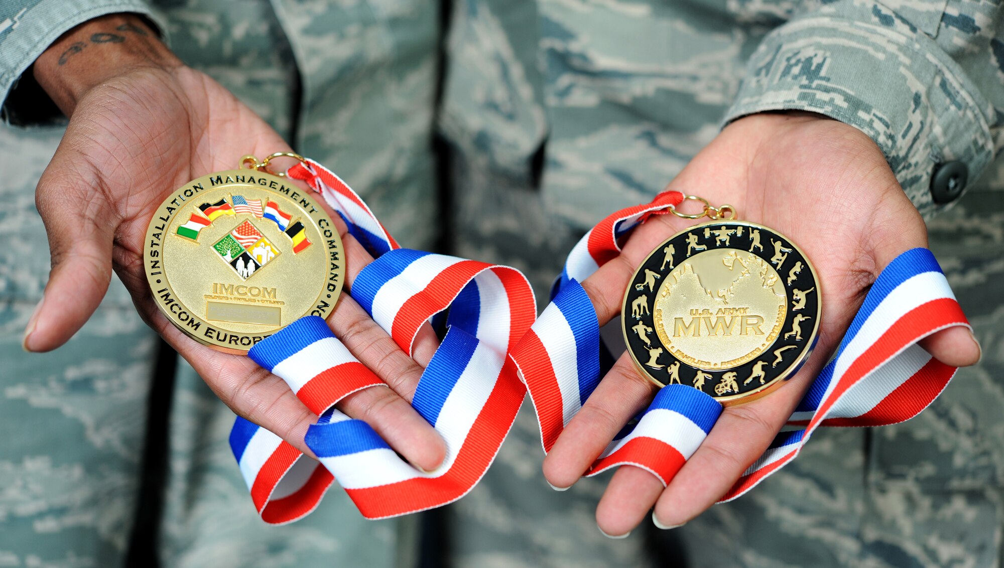 Airmen from the joint RAF Mildenhall and RAF Lakenheath basketball team, the Eagles, show off their gold medals after winning the U.S. Air Forces in Europe/Installation Management Command-Europe Basketball Championship in March 2013. The competition, held in Stuttgart, Germany, was made up of 15 teams from around Europe, including Spain, Italy, Turkey and Germany. The Eagles played in the final against Spangdahlem Air Base, Germany, and took the trophy and the medals. (U.S. Air Force photo by Airman 1st Class Dillon Johnston/Released)