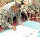 Maj. Gen. Adolph McQueen Jr., deputy commanding general for support, Army North (Fifth Army), signs the Commanders' Proclamation on Sexual Assault Awareness April 3 during the installations Sexual Assault Awareness Month observance at Warfighter and Family Readiness. (Photo by Mike O'Rear, JBSA-Fort Sam Houston Public Affairs)