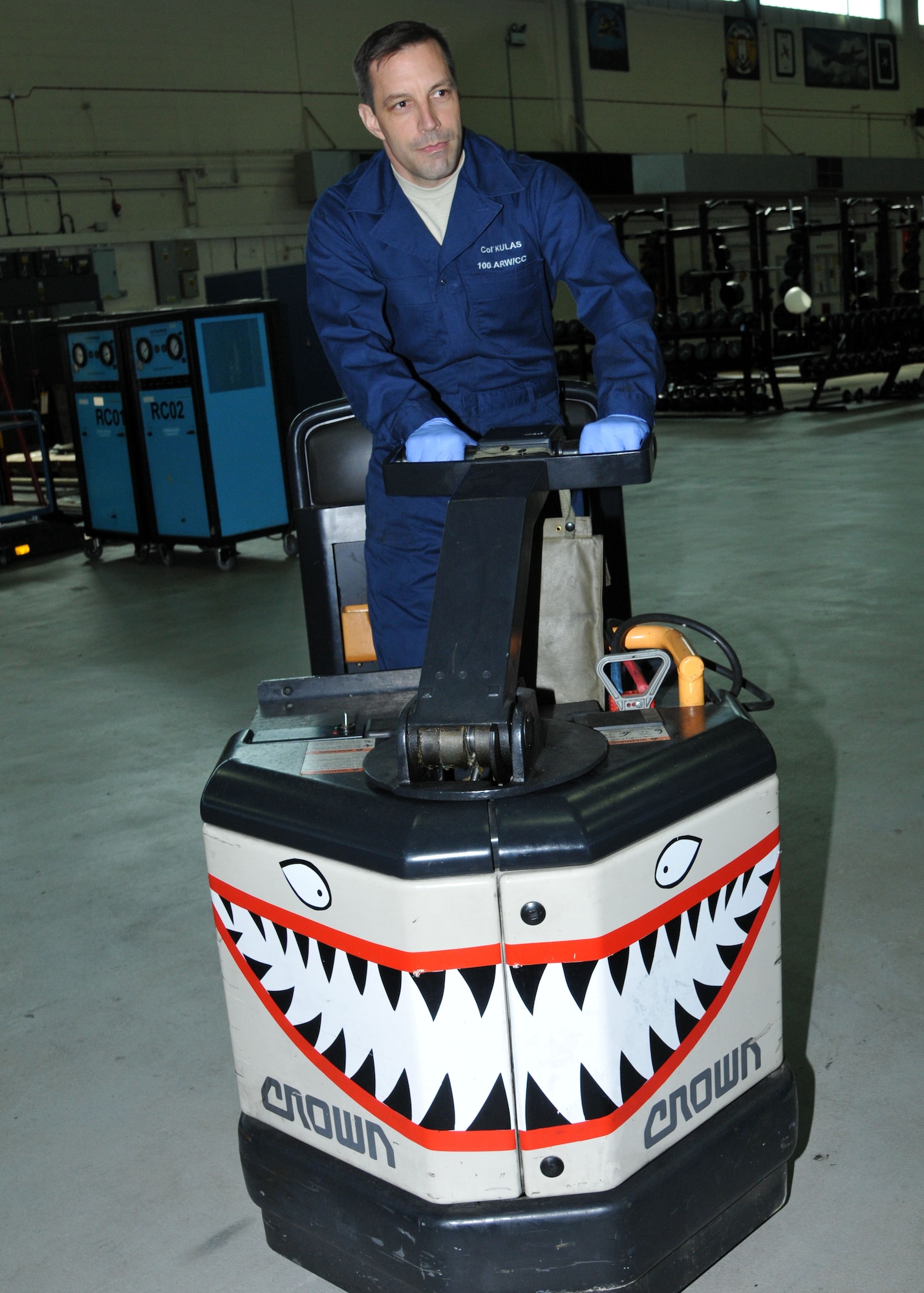 Col. Christopher Kulas, 100th Air Refueling Wing commander, rides a warehouse tug during a “dirty job” April 2, 2013, at building 528 on RAF Mildenhall, England. The “dirty jobs” program is a way for the commander and Chief Master Sgt. Tracy Jones, 100th ARW command chief to experience different jobs on base. (U.S. Air Force photo by Airman 1st Class Kelsey Waters/Released)