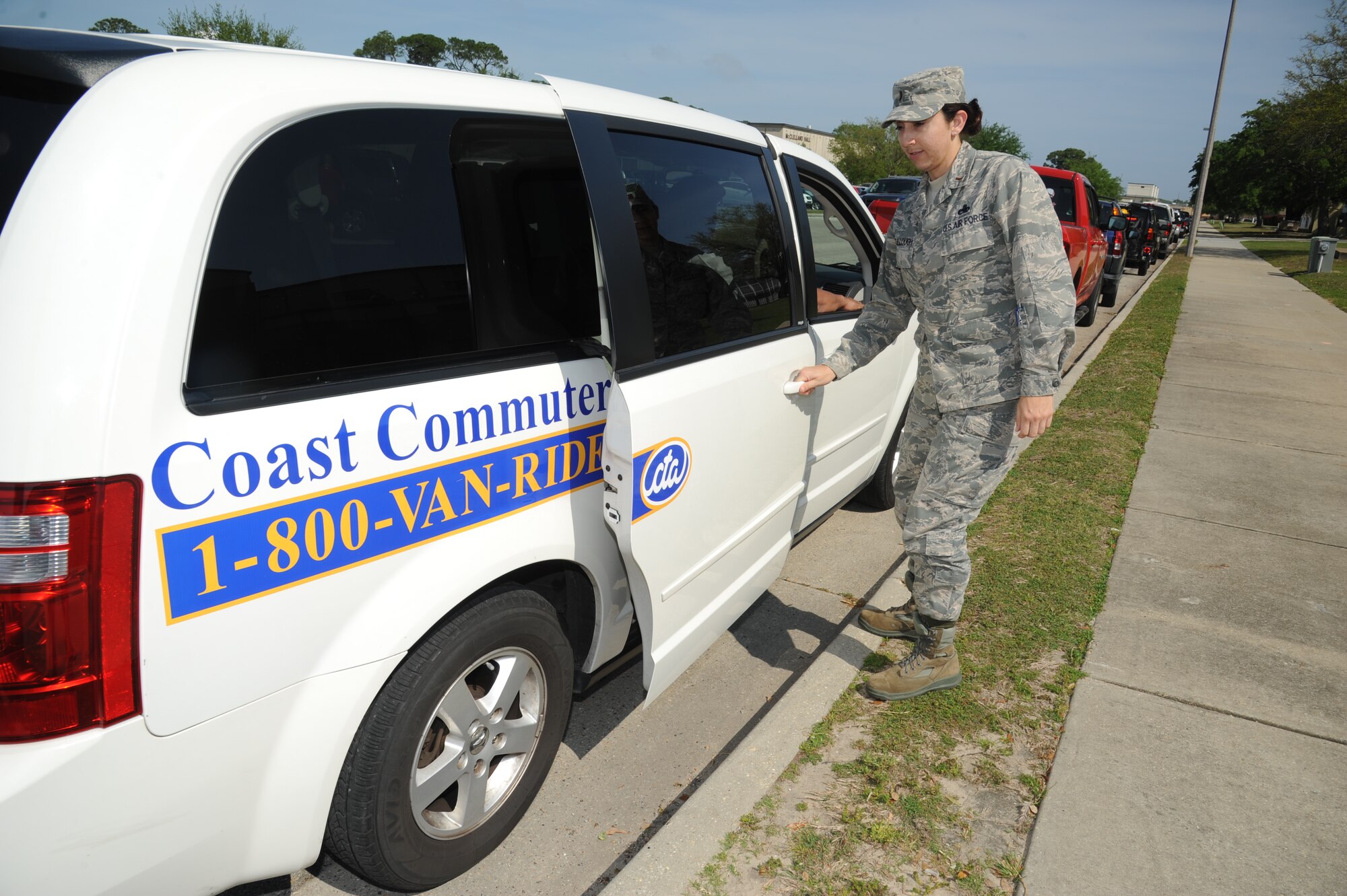 Second Lt. Linda McCullough, 403rd Maintenance Group, and Jerry Mitchell, 81st Logistics Readiness Squadron, are picked up by Scott Ferrara, 403rd Wing, in a Coast Commuter van after work April 10, 2013, at Keesler Air Force Base, Miss., as part of the VRide van pool program.  The cost of commuting continues to rise, but now Ferrara and five other Keesler employees are saving money by using an alternative form of transportation – a van pool.  (U.S. Air Force photo by Kemberly Groue)