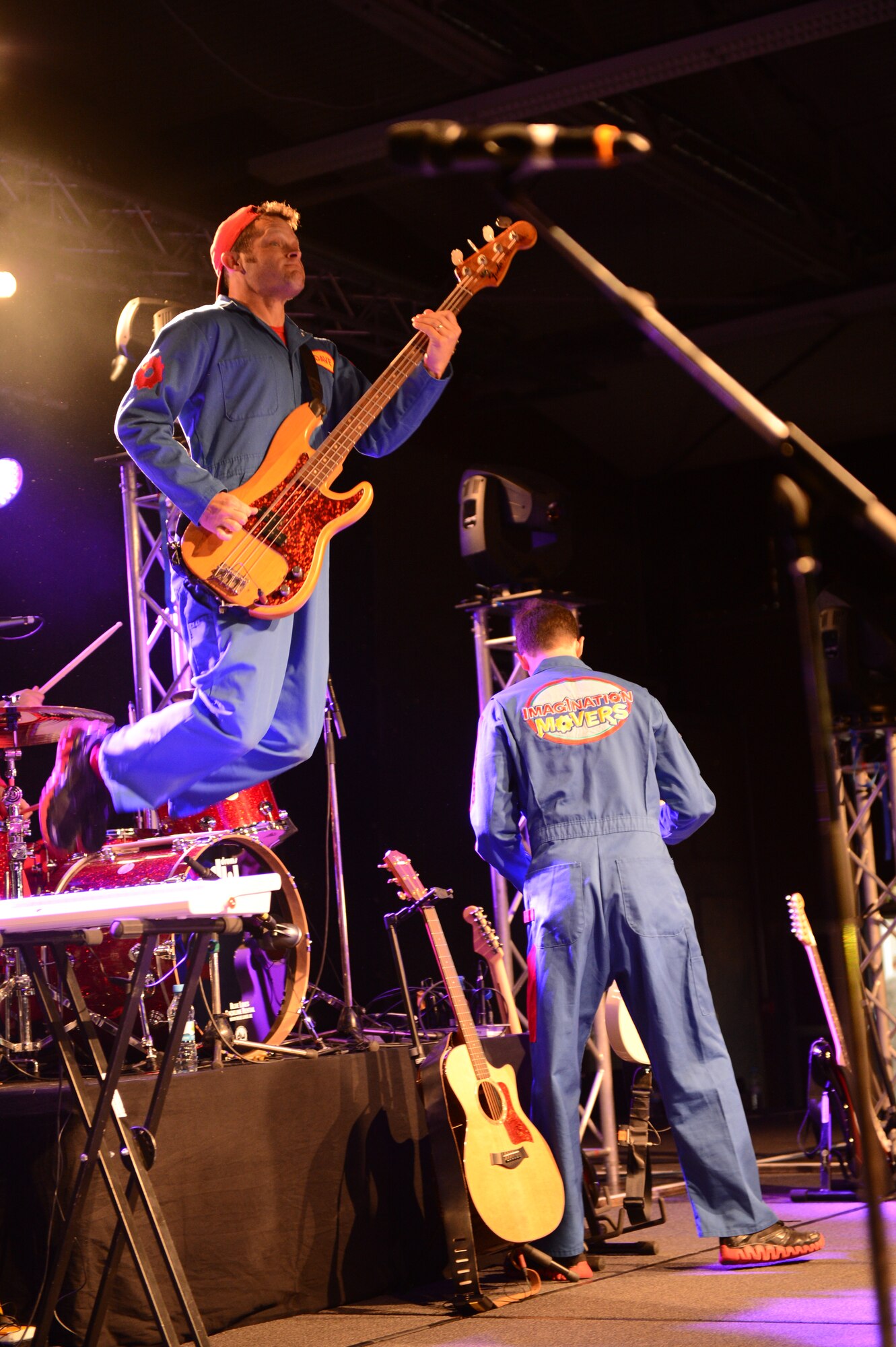 SPANGDAHLEM AIR BASE, Germany – Dave Poche jumps down from the drummer’s podium during the Imagination Movers concert at the Skelton Memorial Fitness Center April 11, 2013. The Imagination Movers were inspired to start the band by their children and tour around the world singing songs about children’s issues like overcoming fears and washing hands. (U.S. Air Force photo by Airman 1st Class Kyle Gese/Released)