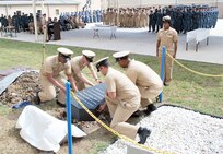 (From left) Chief Petty Officers Mario Lyons and Mike Hill fold the ceremonial flag during the white hat burial ceremony April 1. (Photo by Diana Stevens, Navy Medicine Training Support Center Public Affairs)
