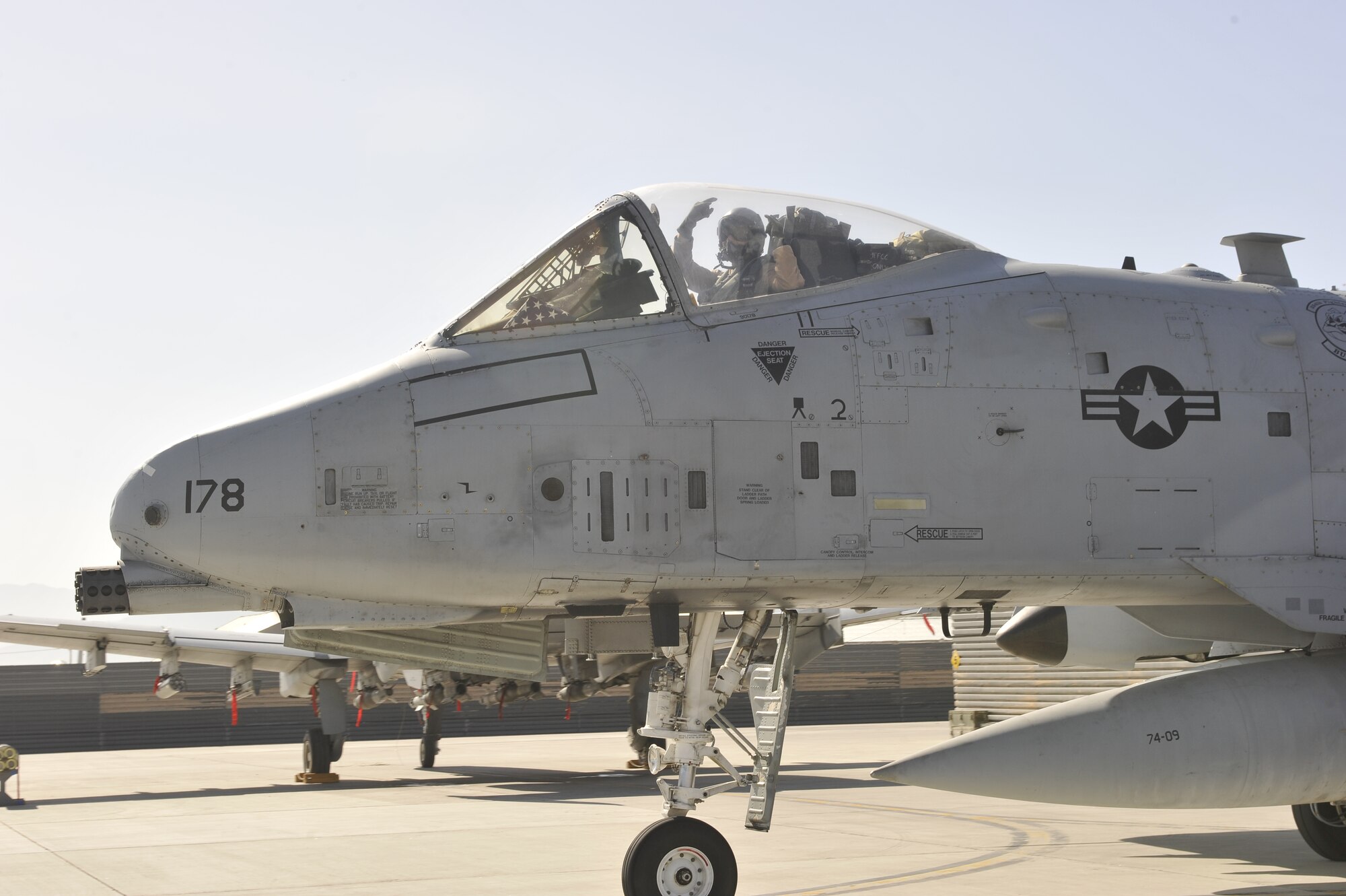 Capt. Kelley Nettleblad, 355th Expeditionary Fighter Squadron A-10 Thunderbolt II pilot, gives a final farewell as she prepares to fly 7,800 miles back home to Davis Monthan Air Force Base, Ariz., from Bagram Airfield, Afghanistan, on April 14, 2013. Nettleblad piloted one of the last three A-10s from Arizona to deploy back home after six months of providing air support to ground troops in Afghanistan. (U.S. Air Force Photo/Master Sgt. Jun Kim)