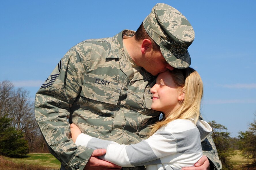 Senior Master Sgt. Kevin Clyatt, 113th Maintenance Group, embraces his daughter, Kira, April 1, 2013, at Joint Base Andrews, Md. (U.S. Air Force photo by Senior Airman Steele C. G. Britton)  