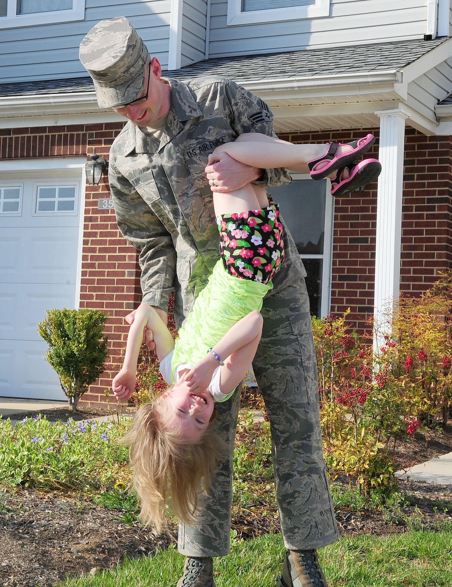 Senior Airman Michael Junk, U.S. Air Force Honor Guard, plays with his daughter, Kathryn, April 9, 2013, at Joint Base Anacostia-Bolling, D.C. (U.S. Air Force photo by Senior Airman Steele C. G. Britton)