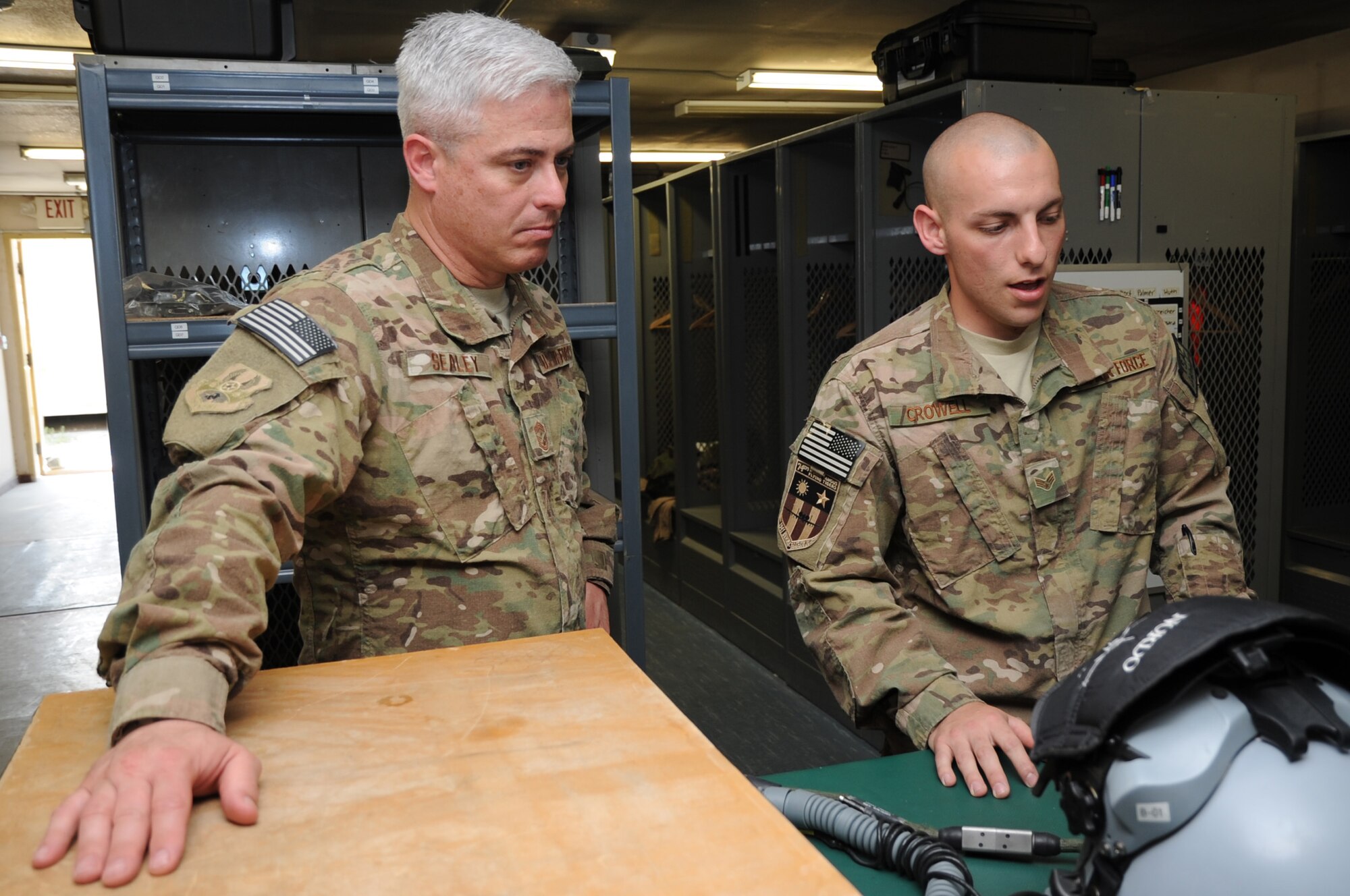 Senior Airman Sean Crowell, 455th Expeditionary Operations Support Squadron aircrew flight equipment technician, describes two helmet-mounted cueing systems to U.S. Air Forces Central Command Chief Master Sgt. Robert Sealey on Bagram Airfield, Afghanistan, April 14, 2013. Sealey visited multiple units on Bagram to meet with Airmen and talk about issues affecting the AFCENT area of operations and the Air Force. (U.S. Air Force photo/Staff Sgt. David Dobrydney)