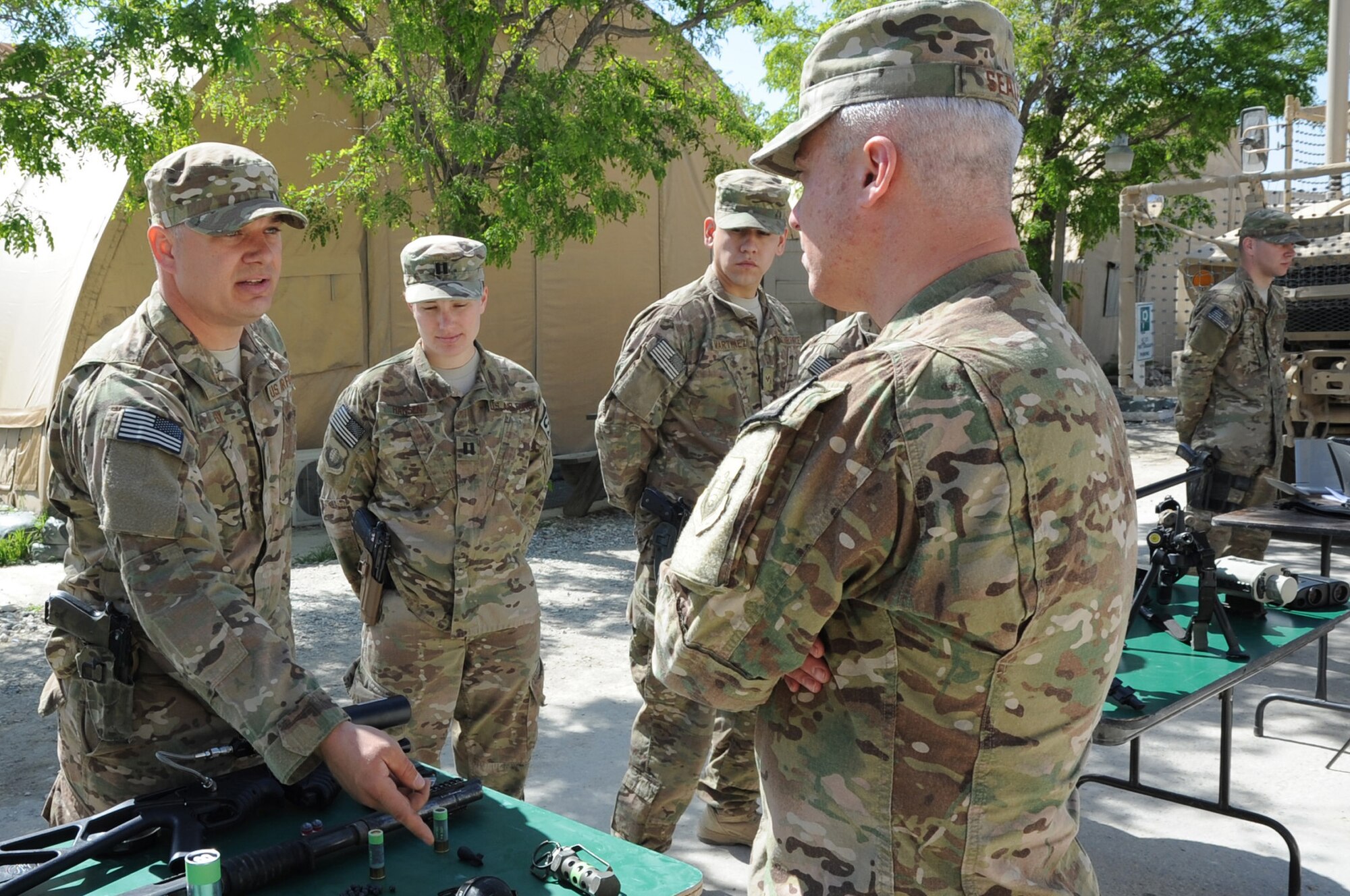 Tech. Sgt. Steven Ely, 455th Expeditionary Security Forces Group combat arms instructor, describes various weapons for crowd control to U.S. Air Forces Central Command Chief Master Sgt. Robert Sealey on Bagram Airfield, Afghanistan, April 14, 2013. Sealey came to Bagram to visit with Airmen and discuss the future of AFCENT operations. (U.S. Air Force photo/Staff Sgt. David Dobrydney)