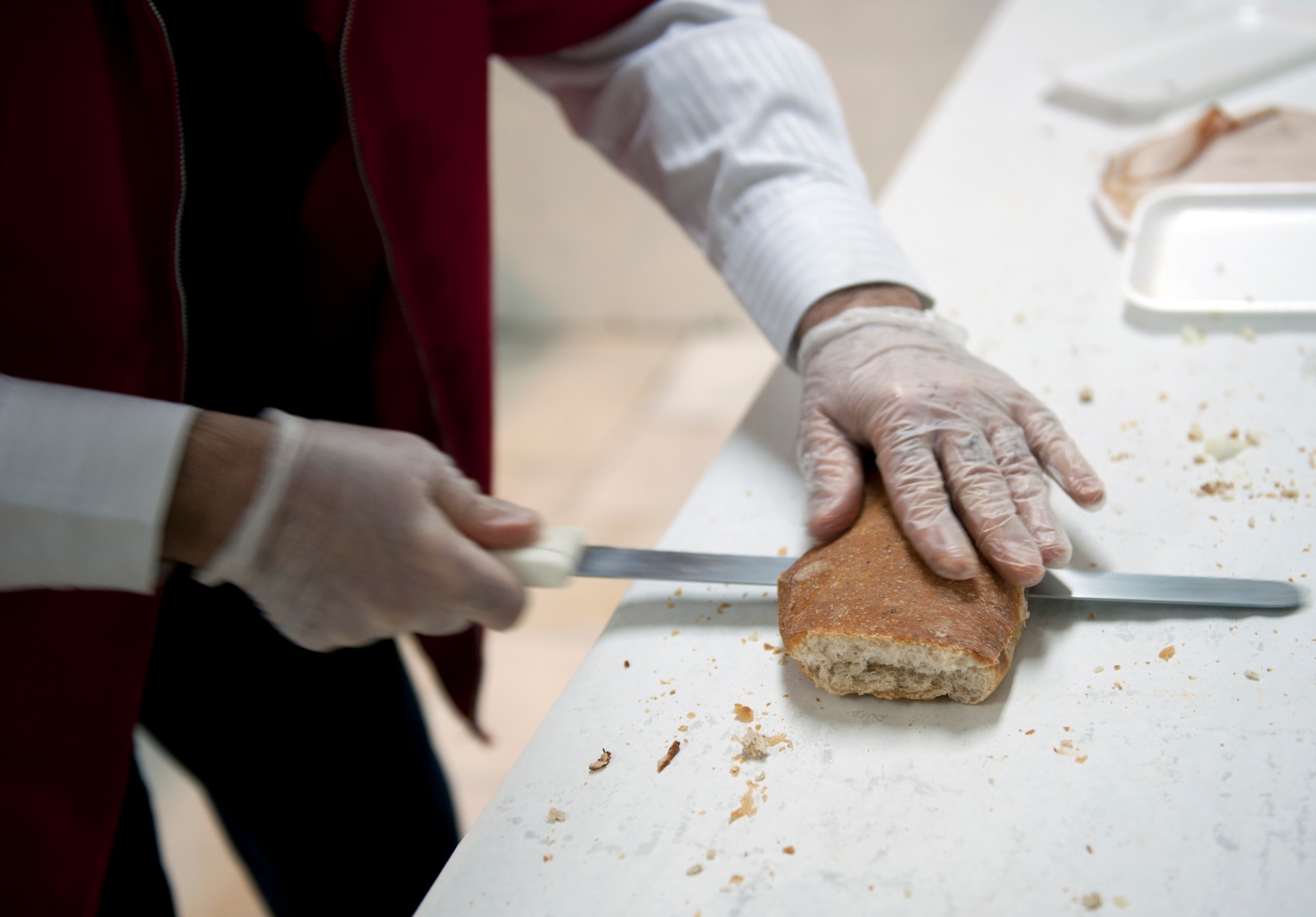 Selami Sahbaz, commissary employee, slices a loaf of bread for a sandwich April 12, 2013, at Incirlik Air Base, Turkey. The Incirlik Commissary opened up a sandwich shop in the deli for Team Incirlik members to order custom sandwiches. (U.S. Air Force photo by Senior Airman Daniel Phelps)