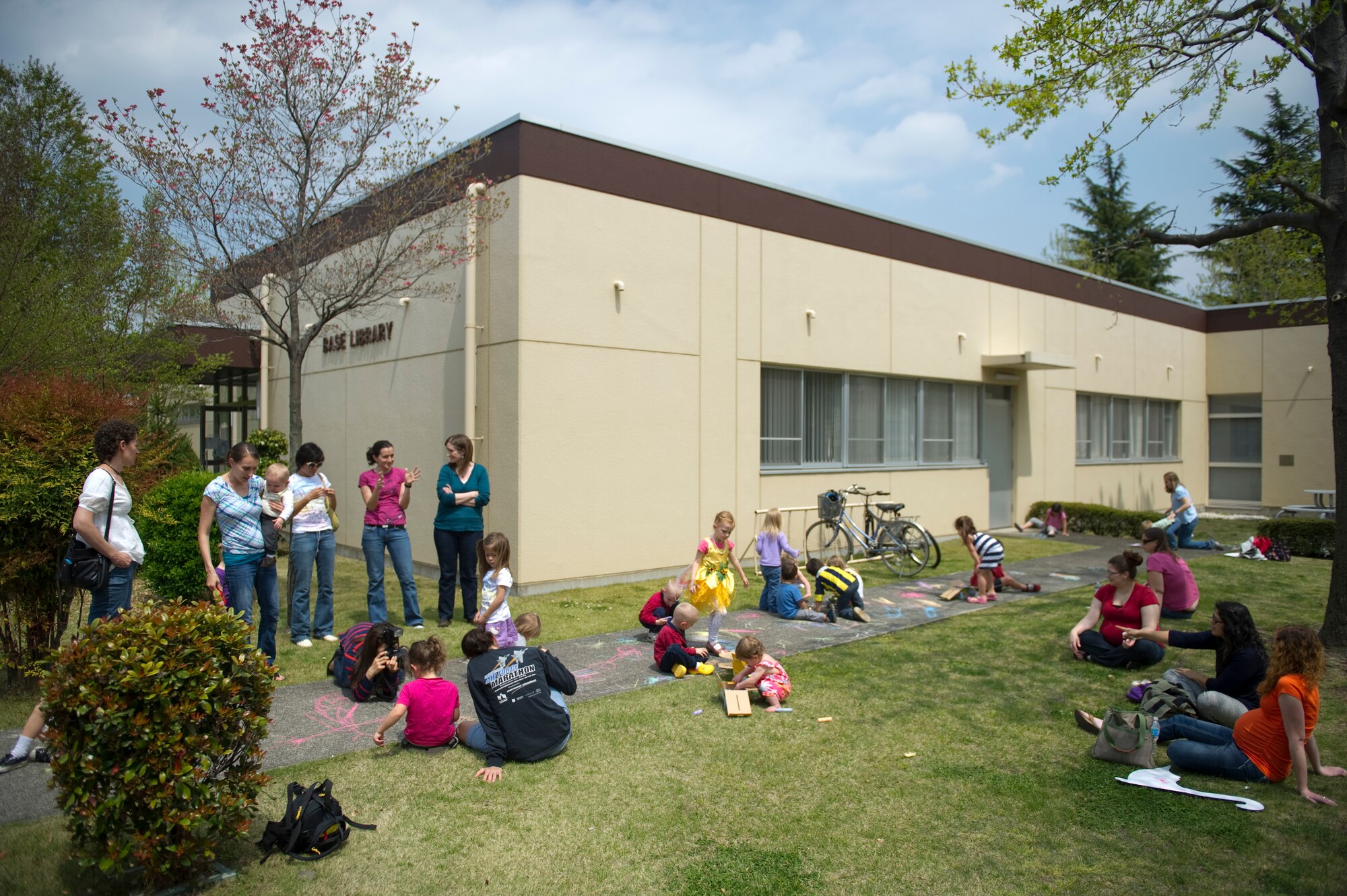 YOKOTA AIR BASE, Japan – Children draw on the sidewalk with chalk outside the base library at Yokota Air Base, Japan, April 15, 2013. Approximately 15 children took part in the second annual chalk drawing event. (U.S. Air Force photo by Staff Sgt. Chad C. Strohmeyer/Released)
