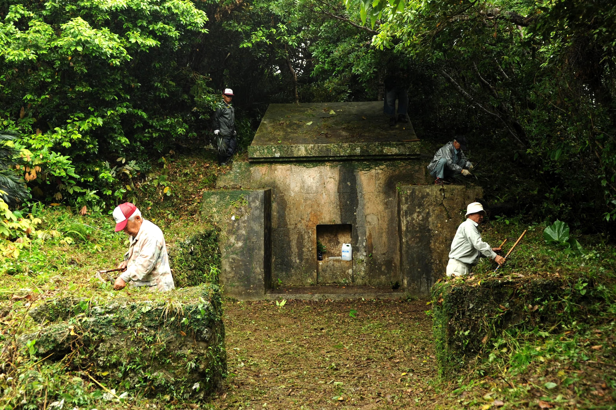 Local Okinawans clean tombs on Kadena Air Base, Japan, April 14, 2013. More than 400 local nationals and their families from across the island visited the munitions storage area to worship their ancestors during an annual religious event.  (U.S. Air Force photo by Airman 1st Class Hailey R. Davis/Released)